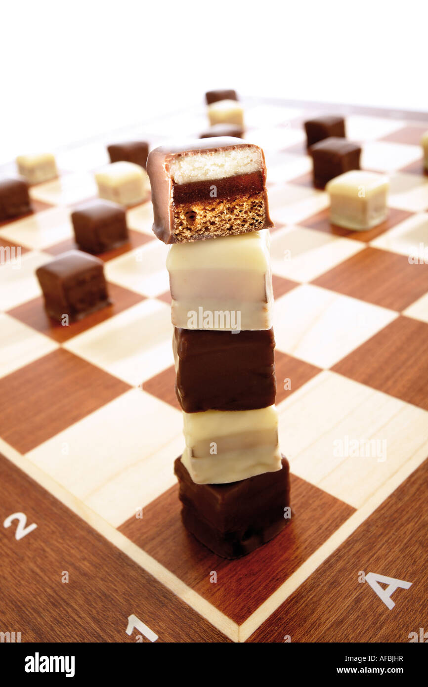 Domino cookies on chessboard Stock Photo