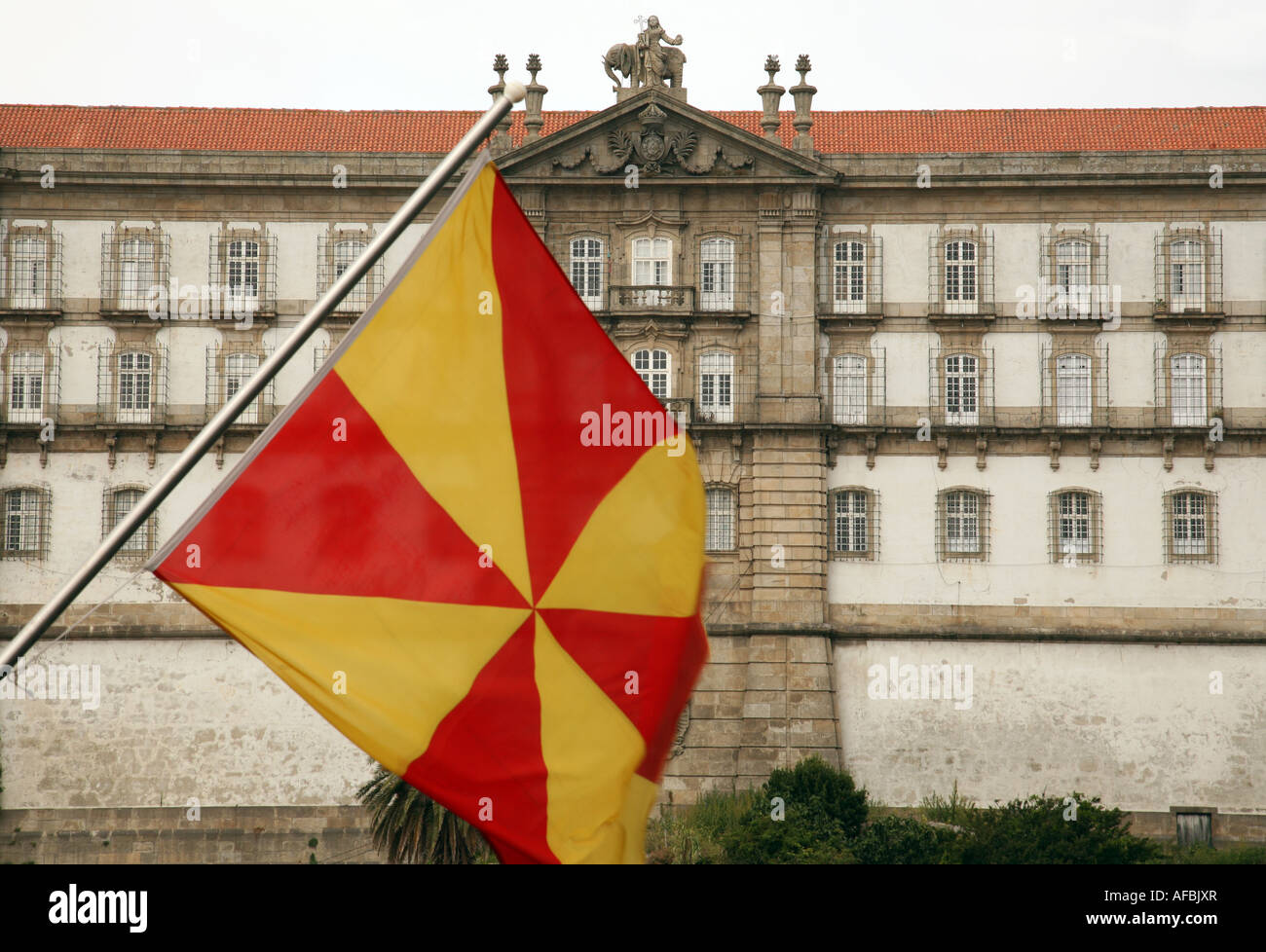 Yellow and red flag flying in front of the Convent of Santa Clara, Vila do Conte, Northern Portugal Stock Photo