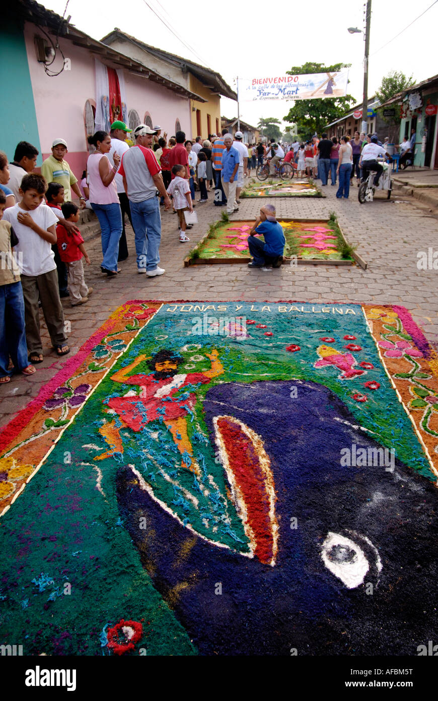 Young man prepares a sawdust carpet for the Good Friday procession, Calle de las Alfombras, Leon, Nicaragu Stock Photo
