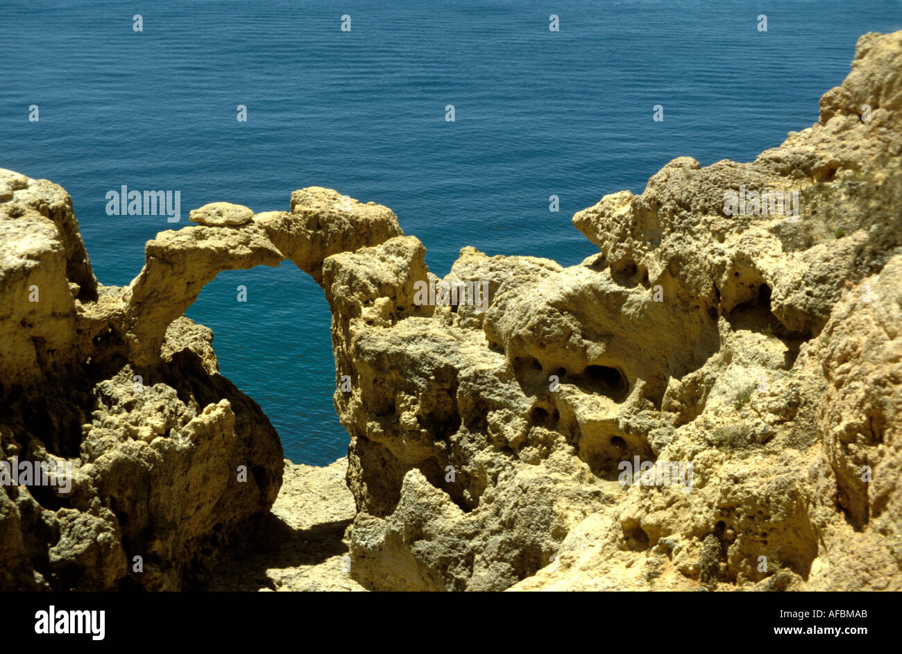 A natural gate at the rocky coatline of the Algarve near Lagos Stock Photo