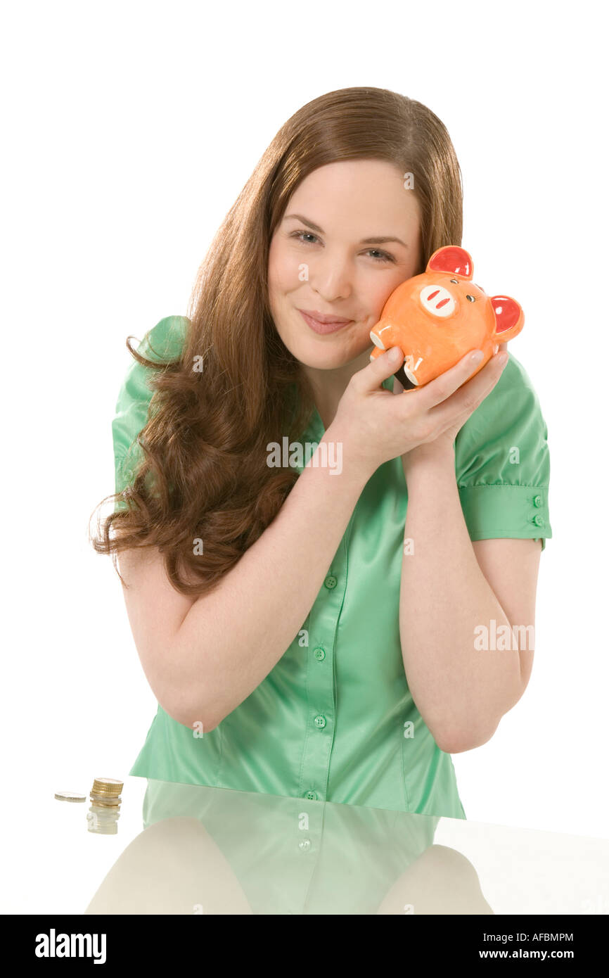 Young woman holding piggy bank, portrait Stock Photo