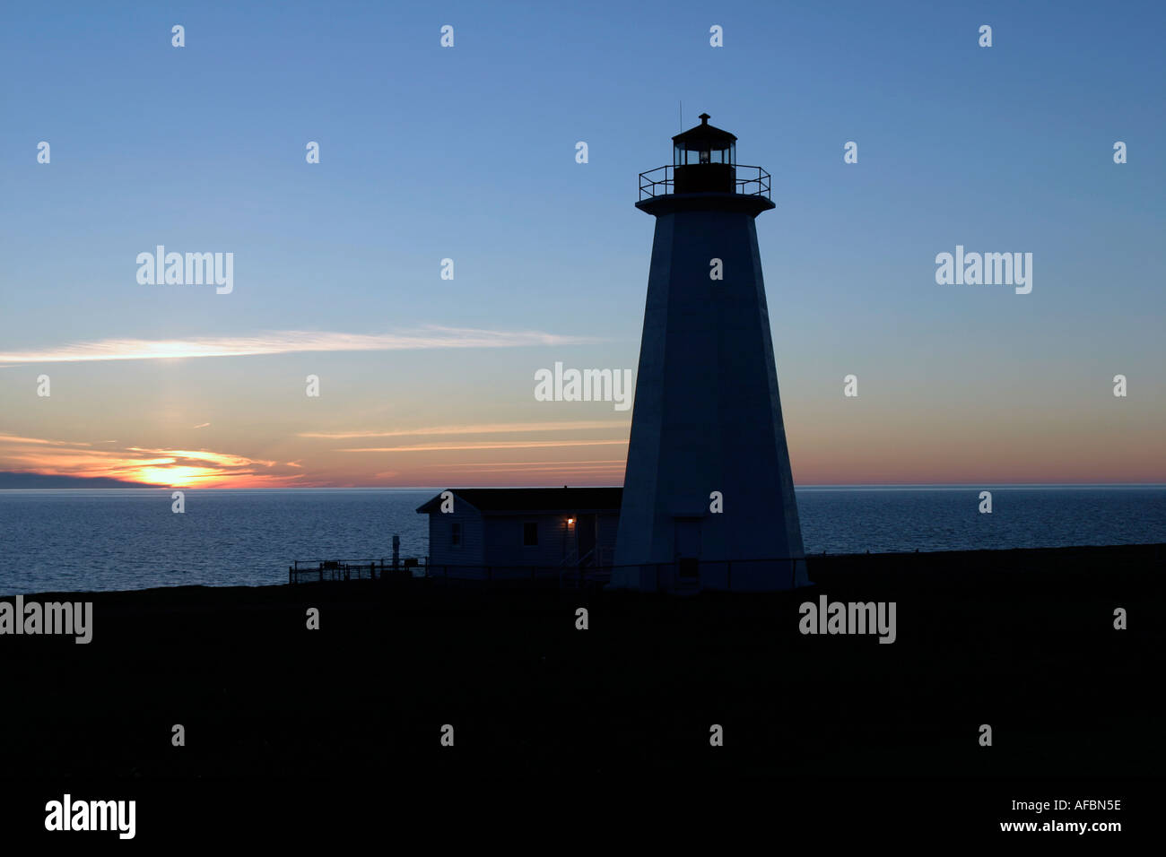Sunset over Cape Anguille Lighthouse standing guard overlooking Gulf of St. Lawrence, Newfoundland, Canada Stock Photo