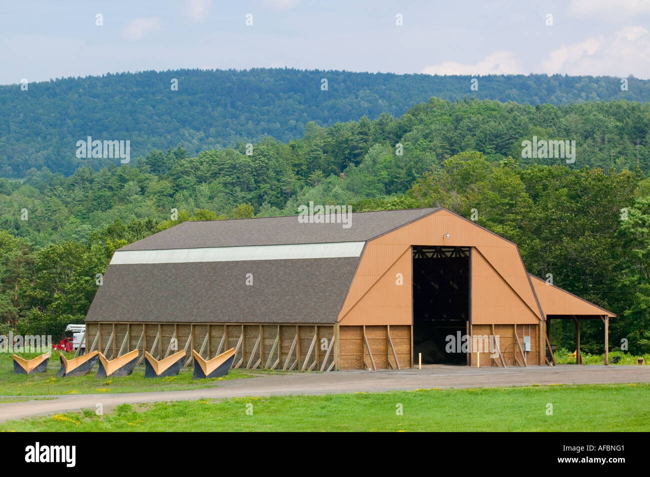 Typical American town utility shed garage in summer with snow plow