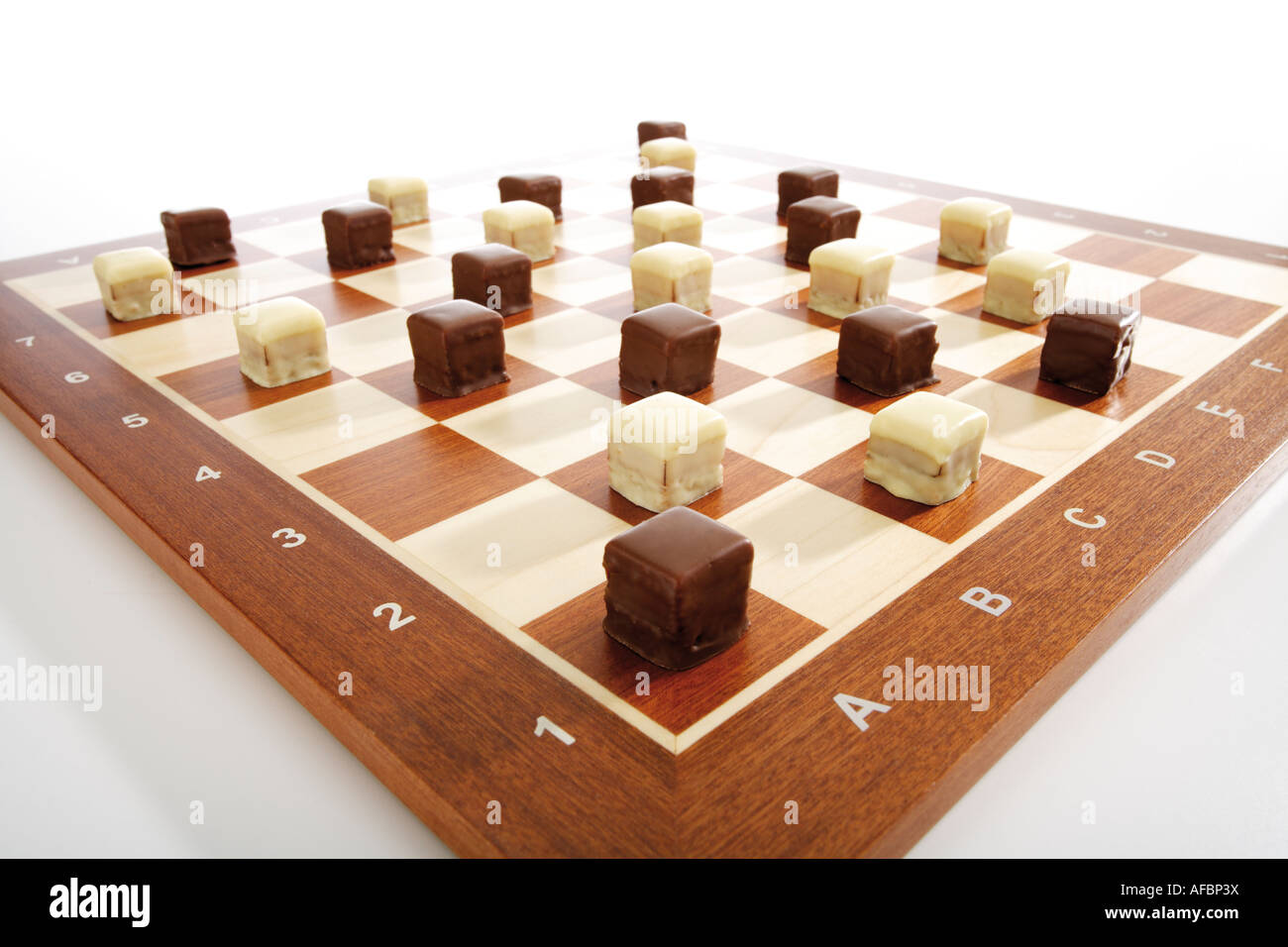 Domino cookies on chessboard Stock Photo