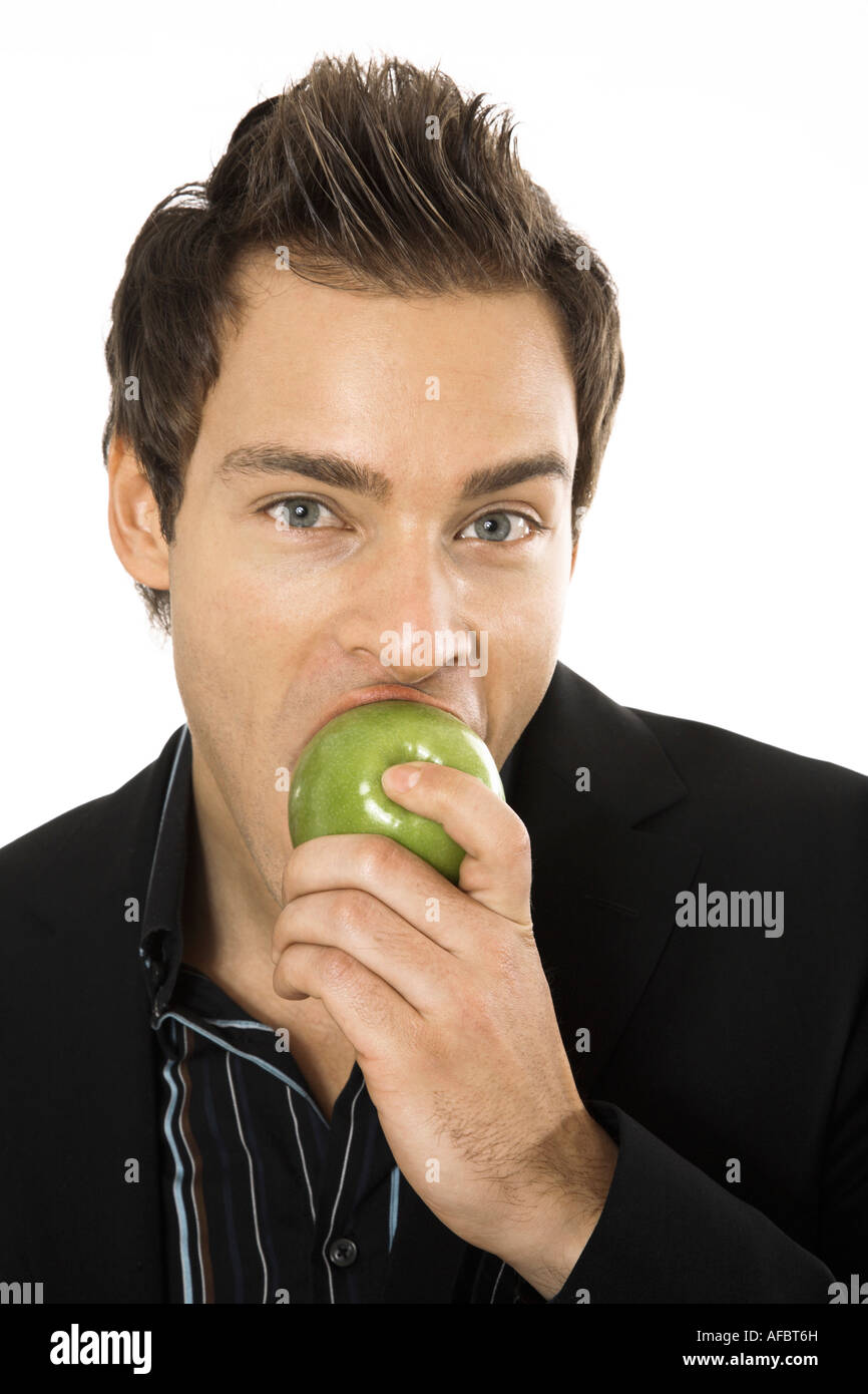 Young man holding green apple, close-up Stock Photo - Alamy