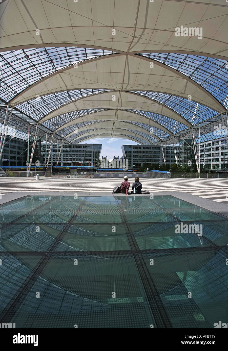 Illustration Airport: Travelers waiting at Munich Airport building with futuristic architecture and reflection Stock Photo