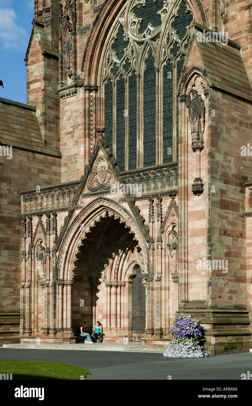 Two people sitting in doorway of Hereford cathedral England UK Stock Photo