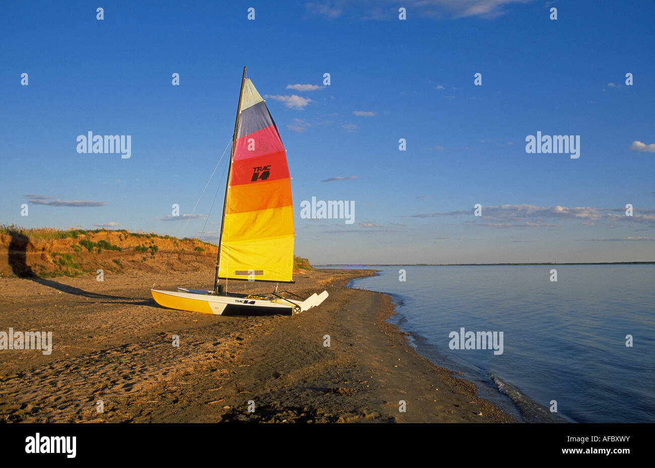 A view of a small sailboat on the beach of lake Diefenbaker in Douglas Provincial Park, Saskatchewan, Canada. Stock Photo