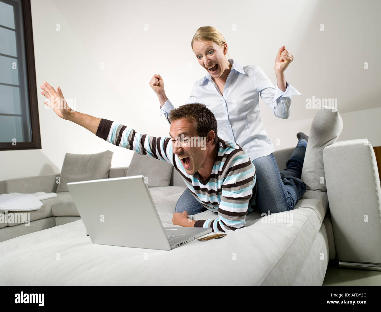 Couple on sofa, using laptop Stock Photo - Alamy