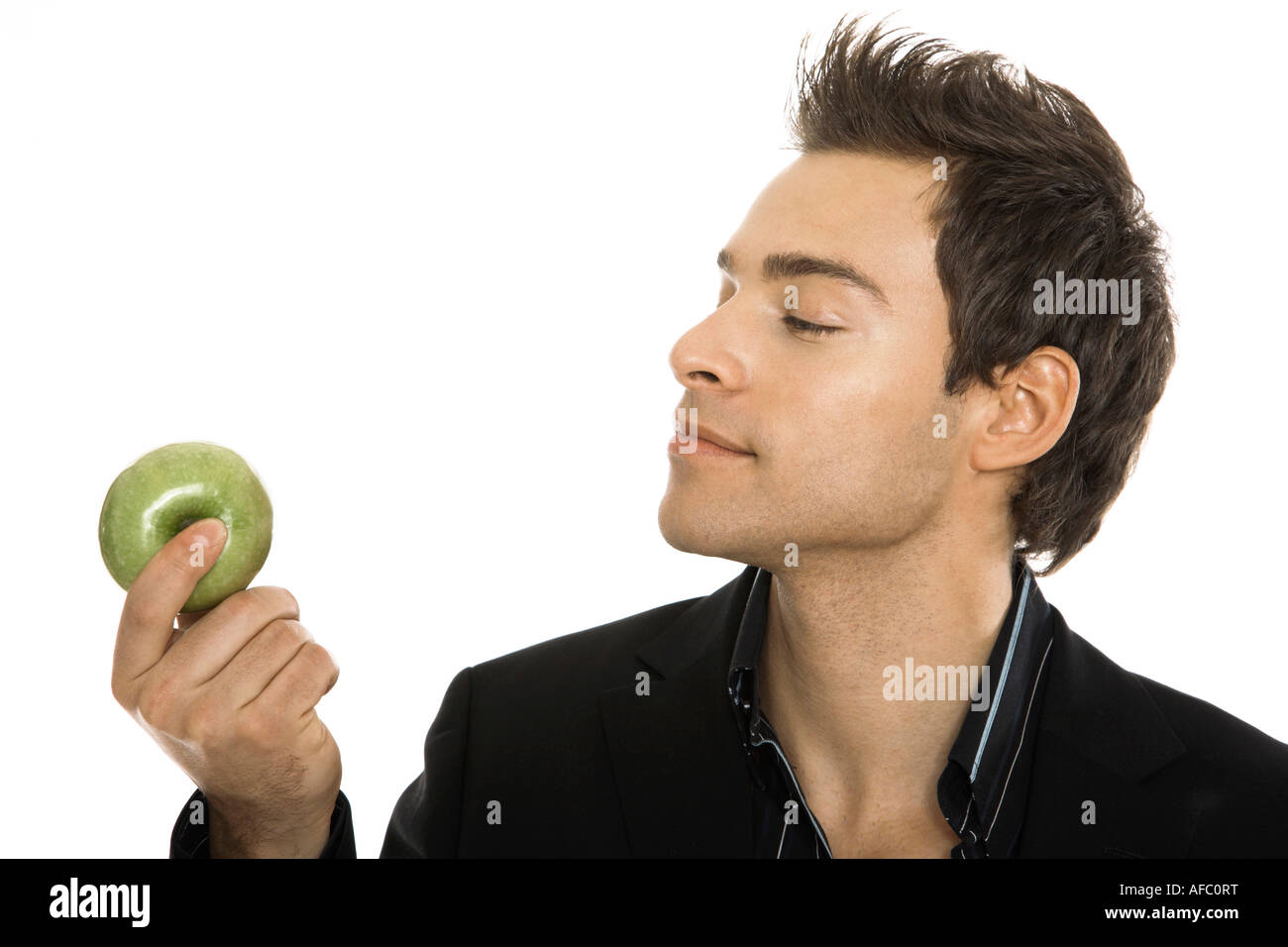 Young man holding green apple, close-up Stock Photo - Alamy