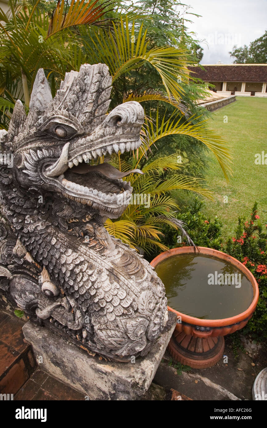 Carved stone ornamental dragon and water bowl feature at the Pha That Luang stupa, Vientiane, Laos. Stock Photo