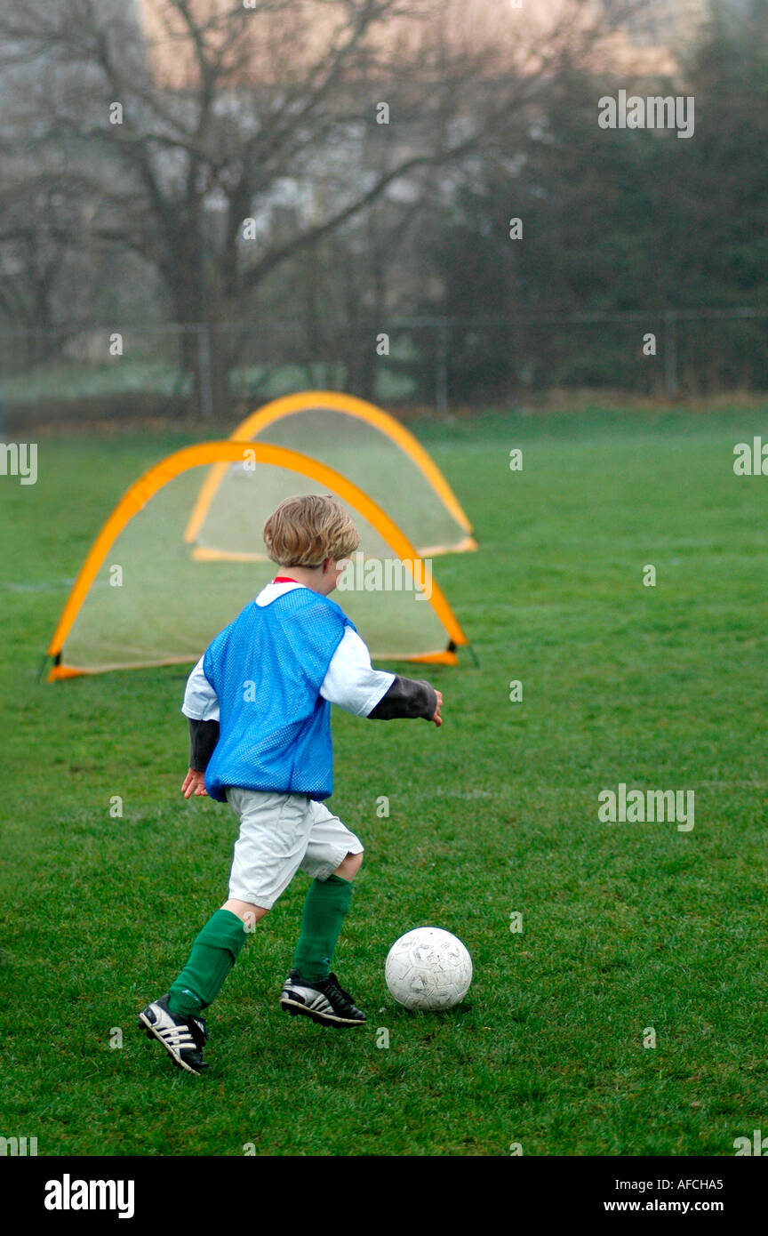 Young boy practicing soccer football Stock Photo