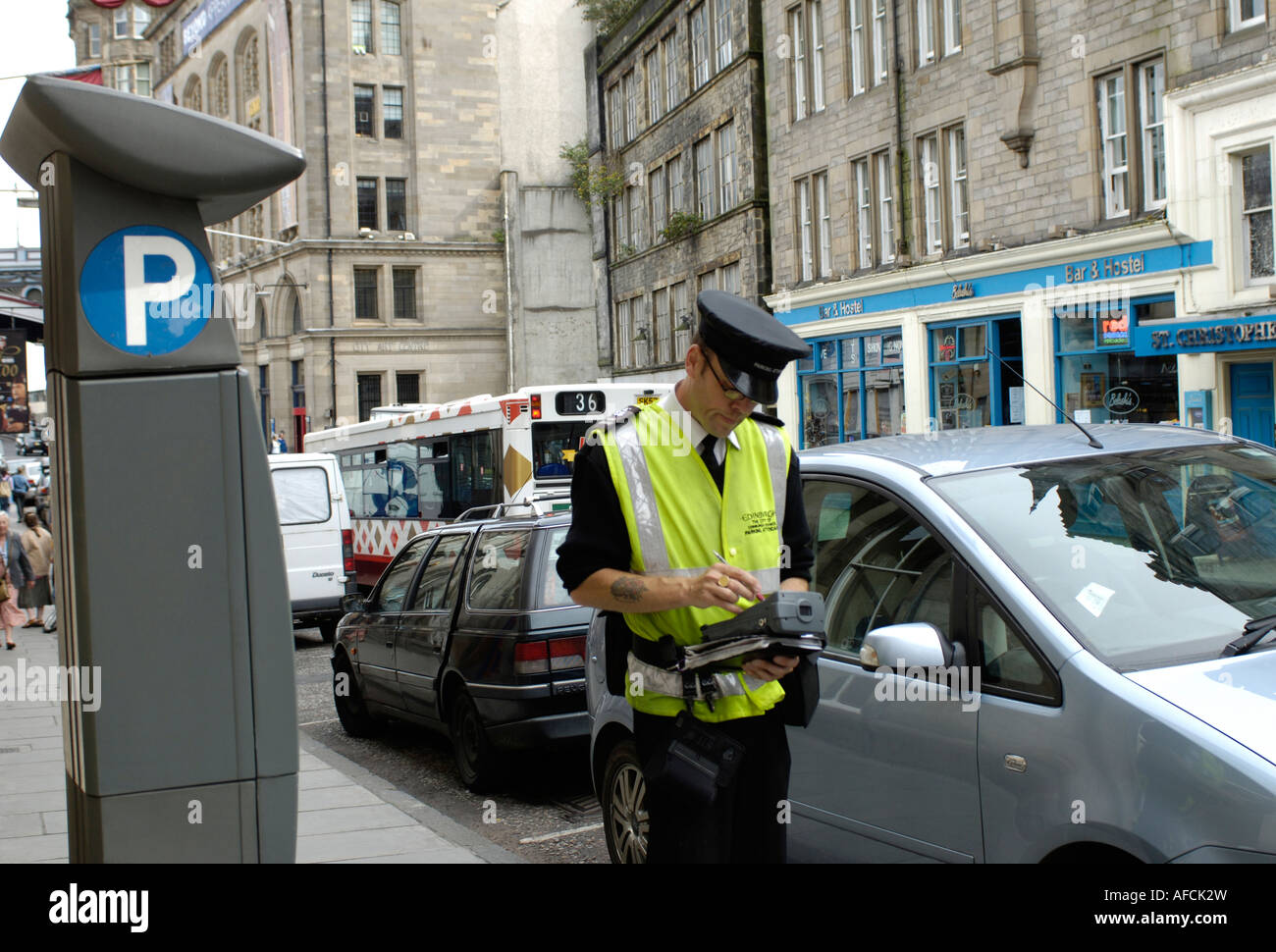 Traffic Warden Parking Attendant writing out ticket for motorists parked car Flourescant Jacket