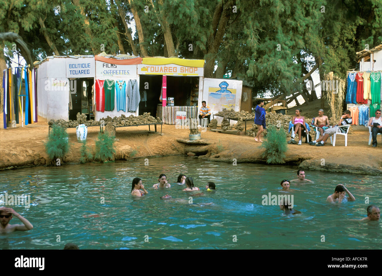 Tunisia, Ksar Ghilane, Sahara Desert, Tourists swimming in natural swimming pool Stock Photo