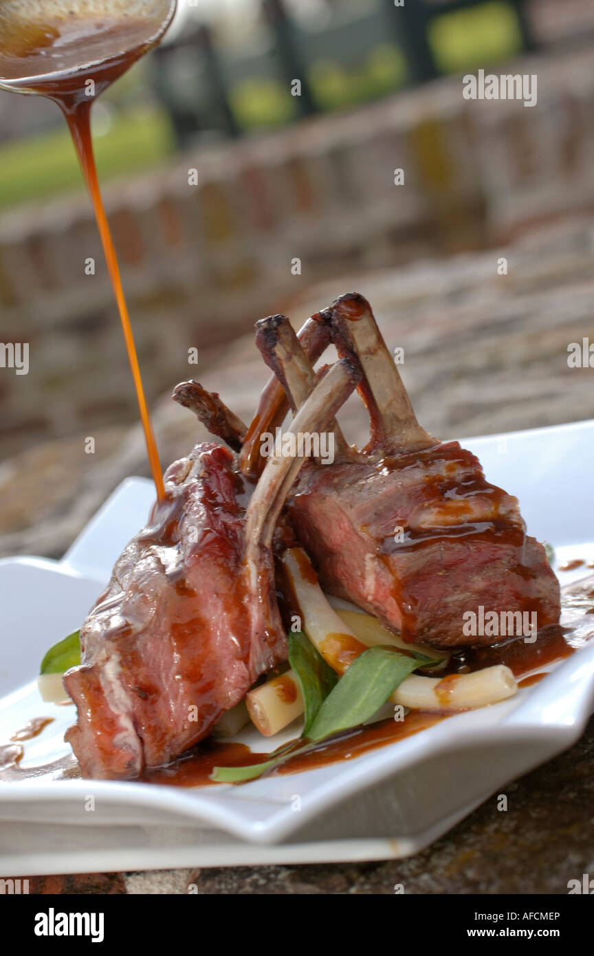 Rack of lamb chops with asparagus spears and gravy Stock Photo Alamy