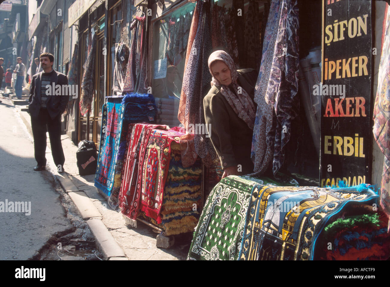 Istanbul Turkey,Turkish Europe Asia,Kucukpazar Quarter,Cakmakcilar Cadessi,rugs and scarves street,sidewalk product products display sale,market,curre Stock Photo