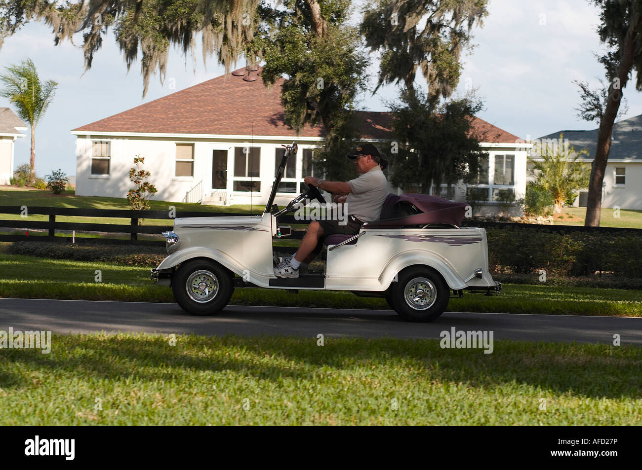A man driving a golf cart in Florida Stock Photo Alamy