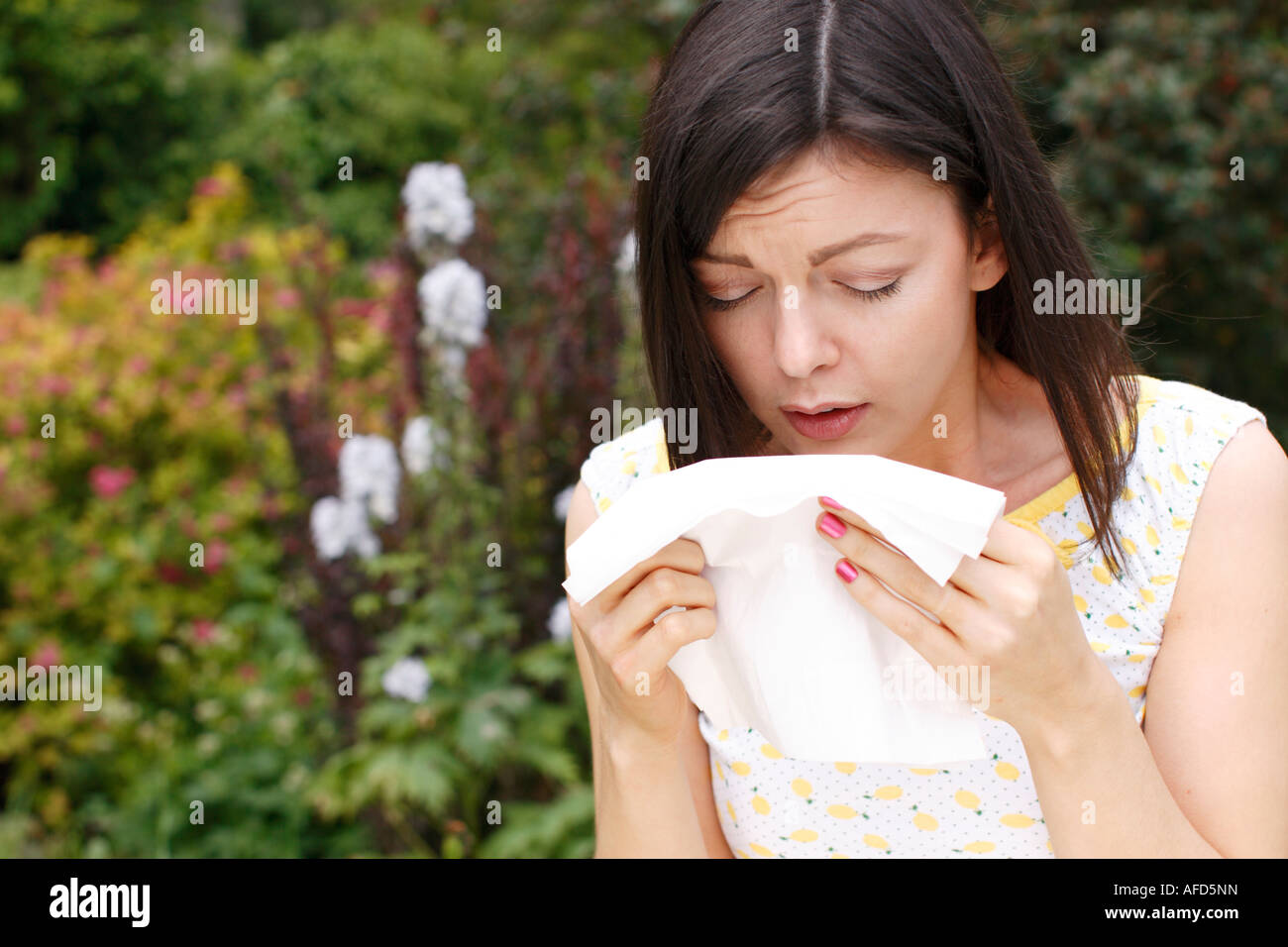 woman sneezing from hayfever Stock Photo