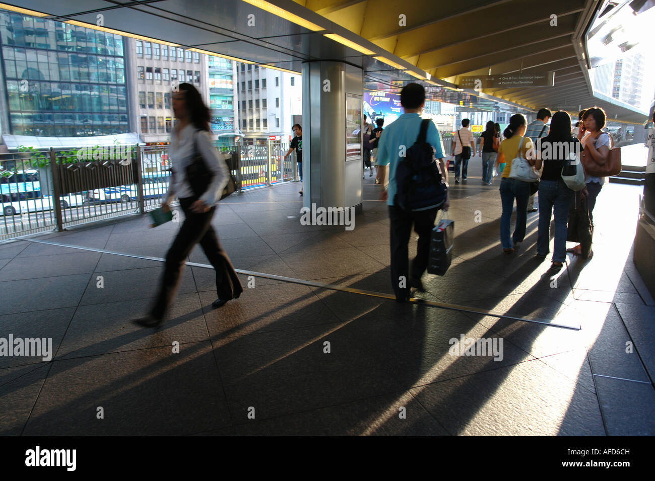 Pedestrians walking on bridge in central district Hong Kong China Stock Photo