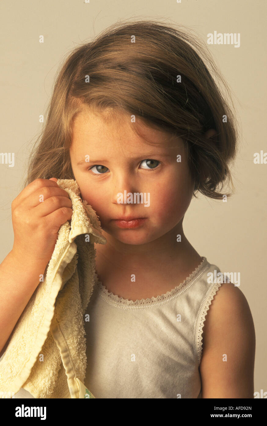 child rubbing her face with a flannel Stock Photo Alamy