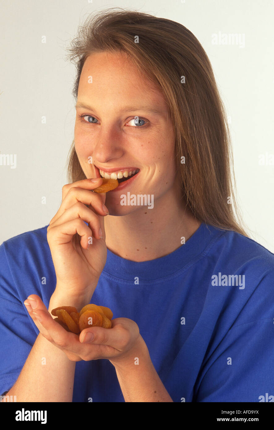 woman eating dried apricots Stock Photo Alamy