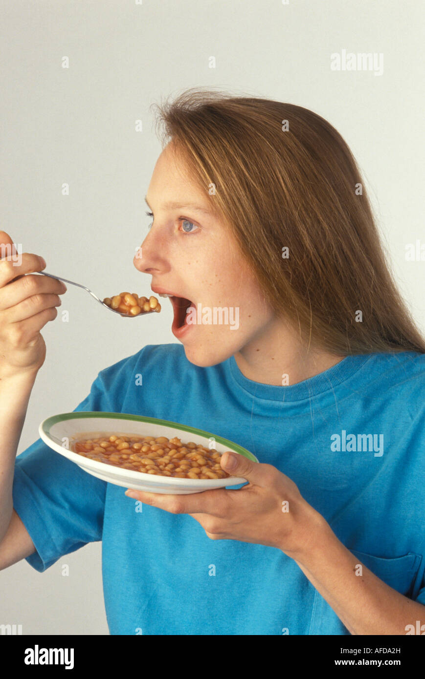 woman eating baked beans Stock Photo Alamy