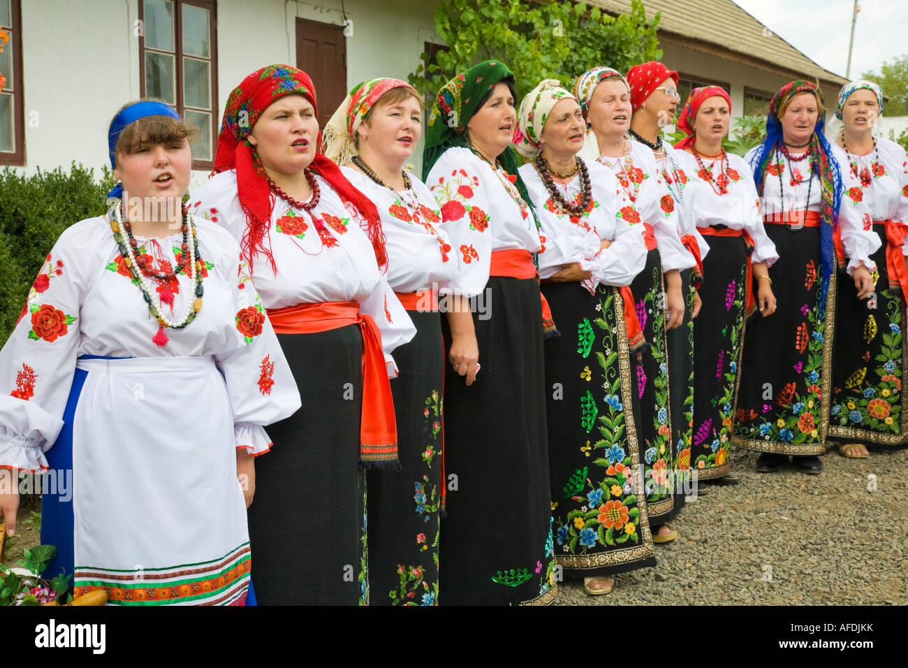 Countrywomen wearing traditional Ukrainian costumes are singing in