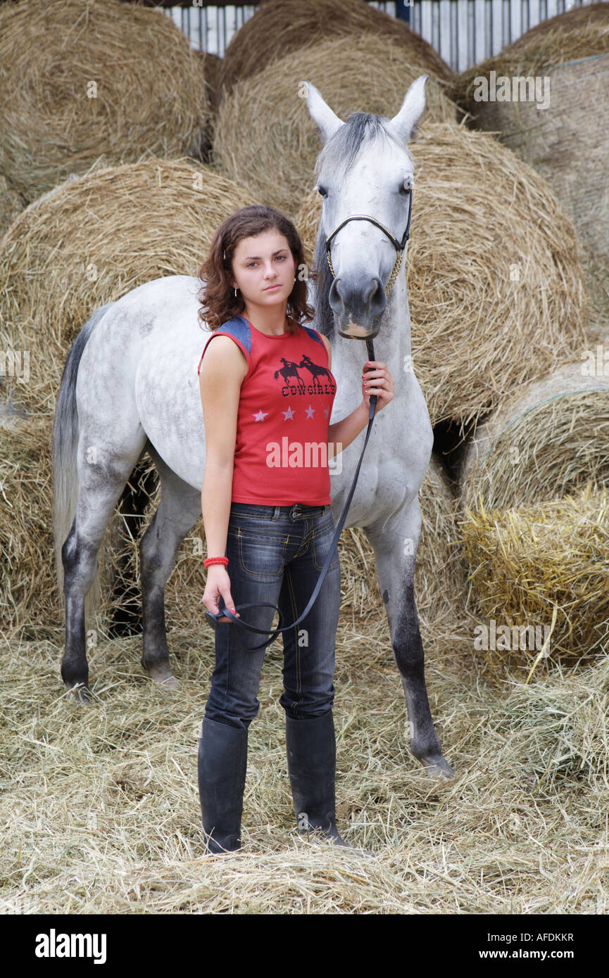 A portrait of farmer girl with white horse Stock Photo