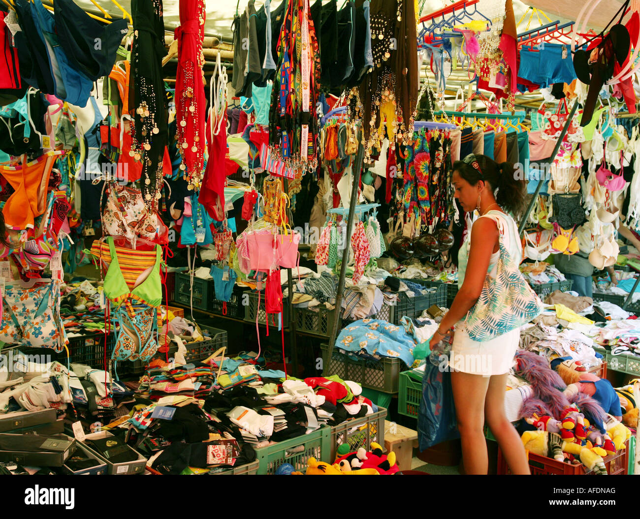 Portugal market - A teenage girl shopping at a clothes stall, the market, 'Viana do Castelo', Portugal, Europe Stock Photo