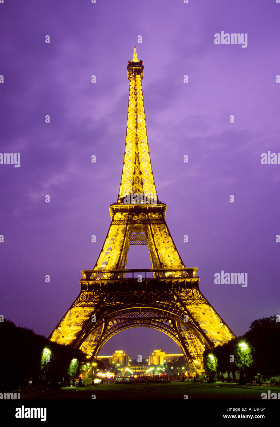 A view of the Eiffel Tower lit up at night over the city of Paris