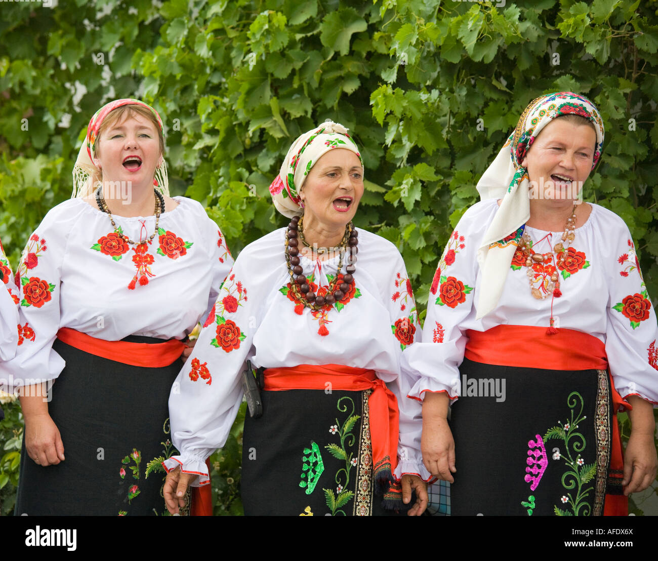 Countrywomen wearing traditional Ukrainian costumes are singing in
