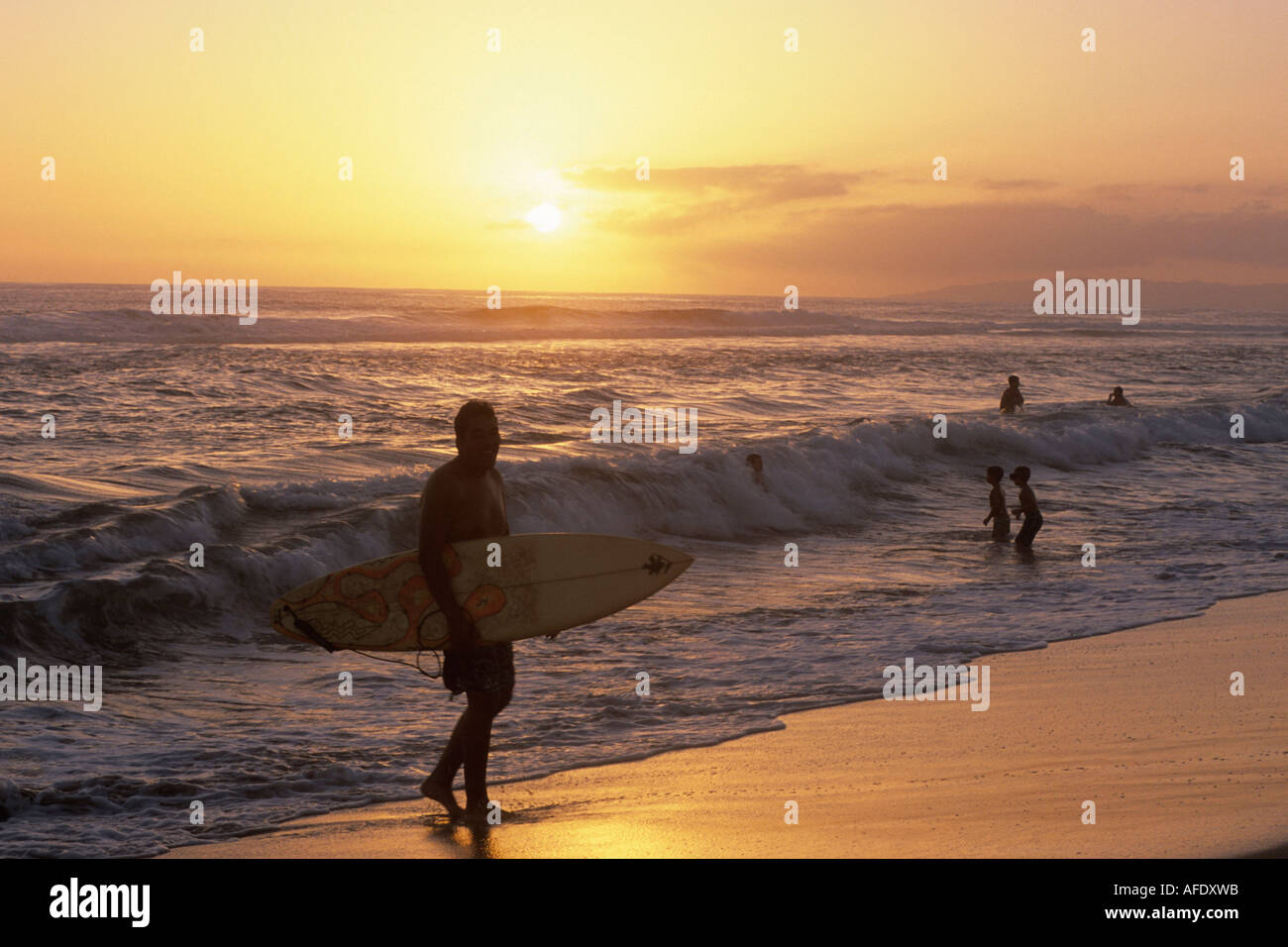 Surfer at Sunset, Kekaha Beach Park, Kekaha, Kauai, Hawaii, USA Stock