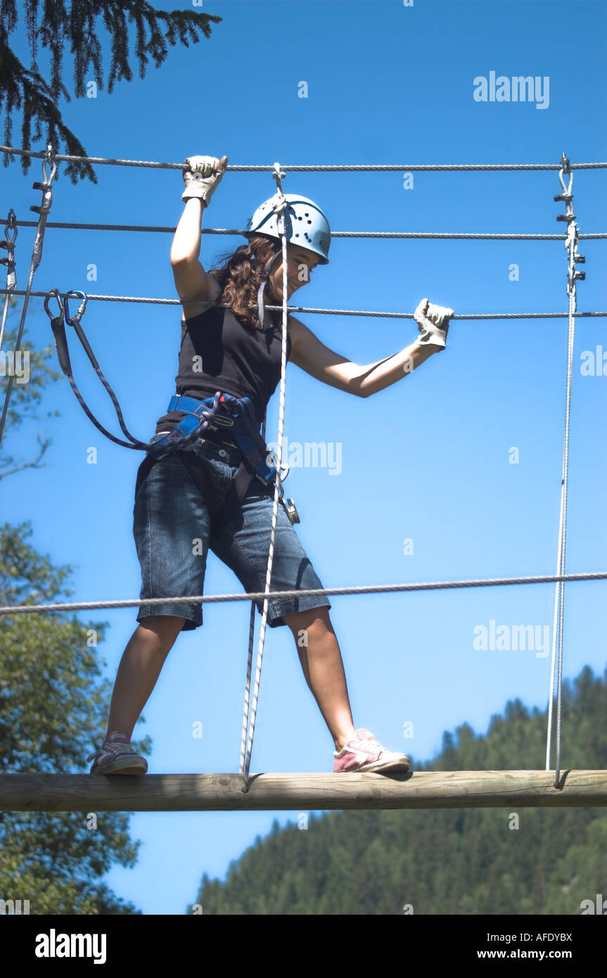 Woman Crossing Rope Girl Crosses Rope Bridge Stock Photo - Alamy