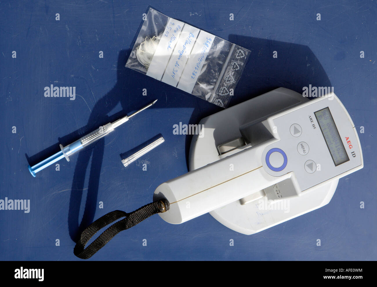 Identification chip with syringe and scanner All data of an animal are saved in it and readable Stock Photo