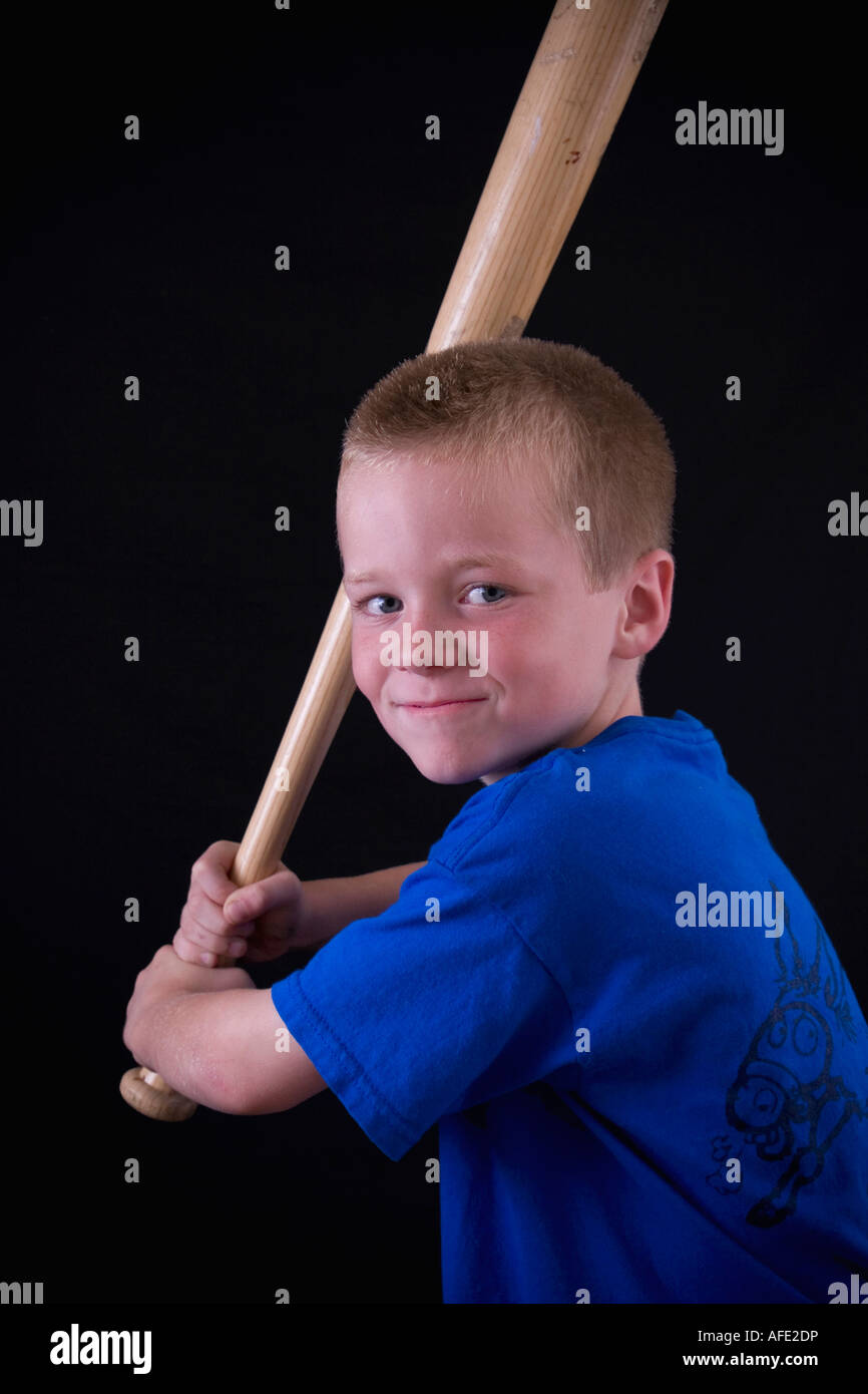 Cute little blonde boy holding a baseball bat Stock Photo