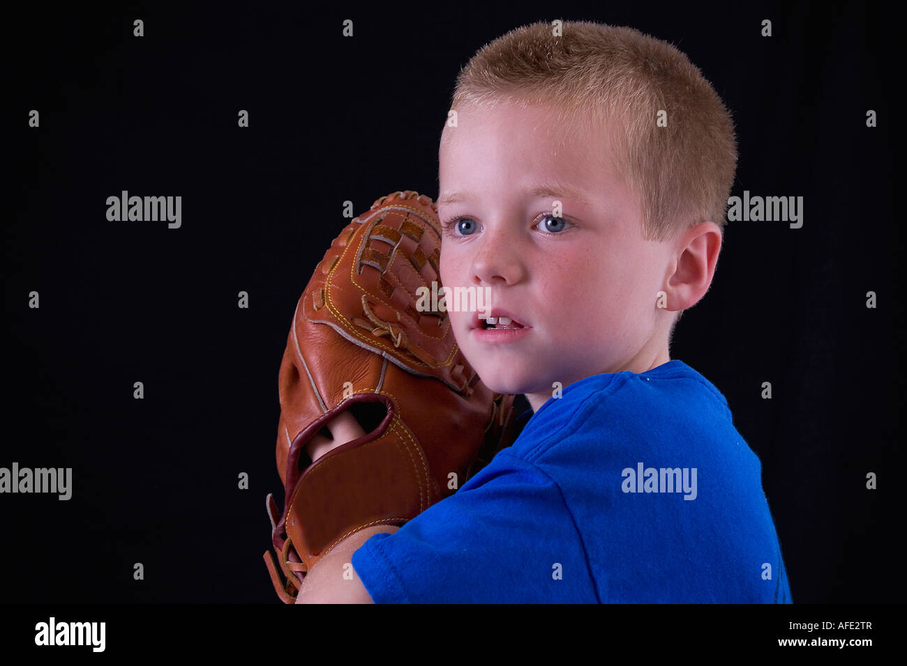 Little blond little league player ready to pitch the ball Stock Photo