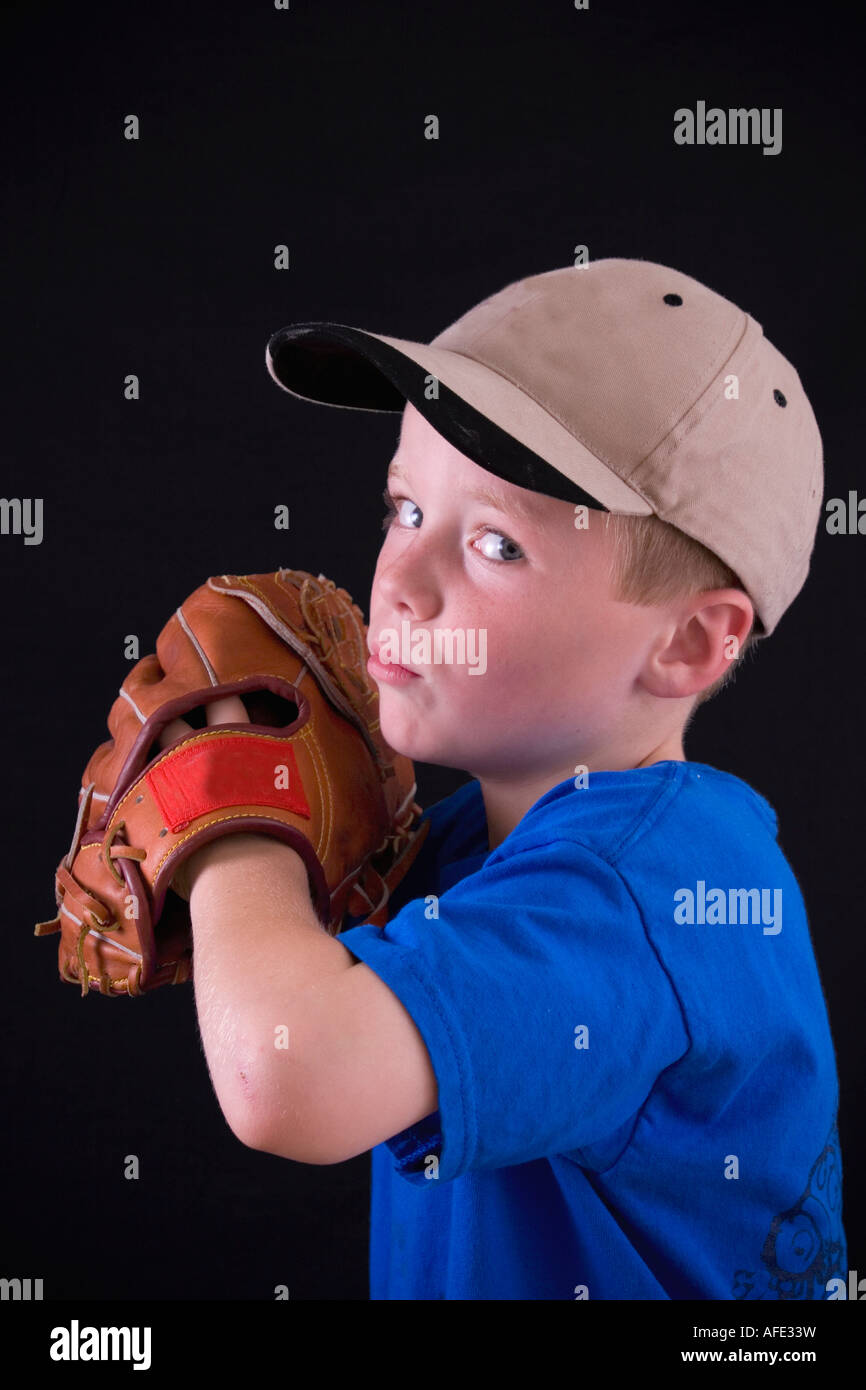 Little boy with baseball cap and glove ready to pitch the ball Stock