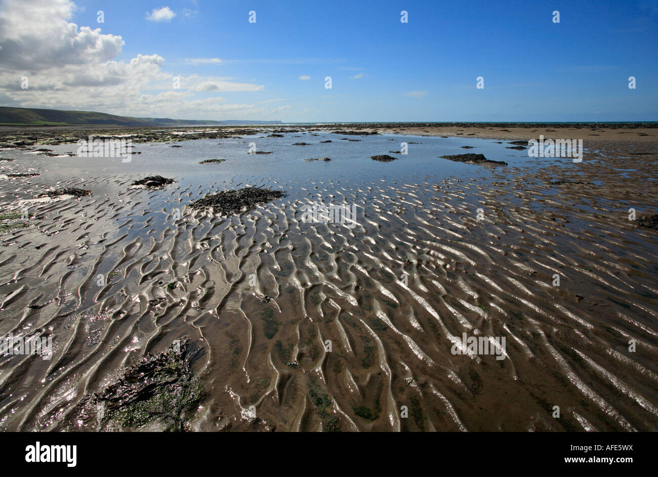 Ripples in sand and rock pools on Llanon beach, Wales. Stock Photo