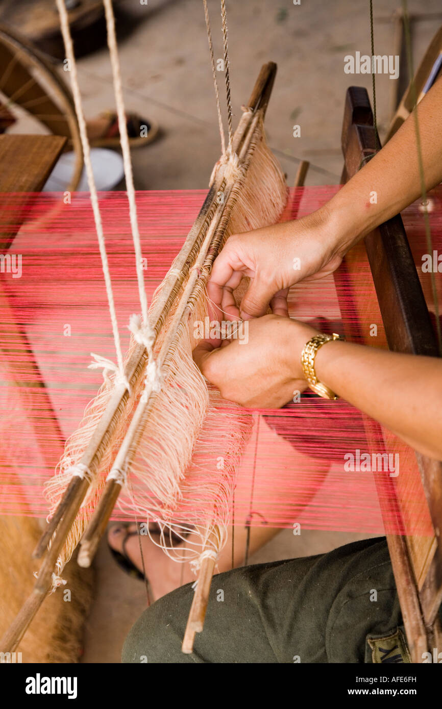 Hands on loom making scarf to sell to tourtists near Ban Na Thong village Vang Vieng Laos Stock Photo