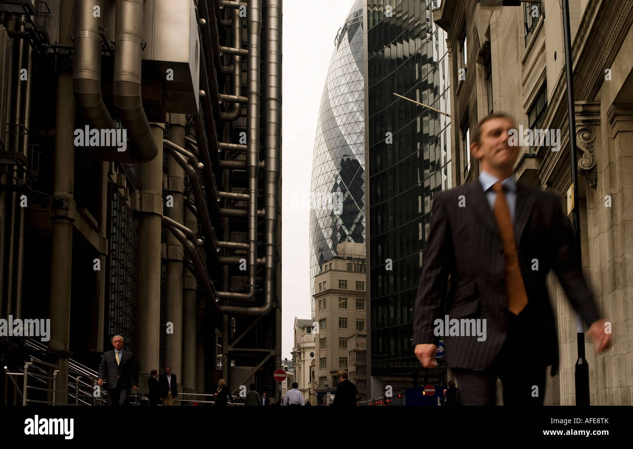 City worker businessman walking past Lloyds London England UK Stock Photo