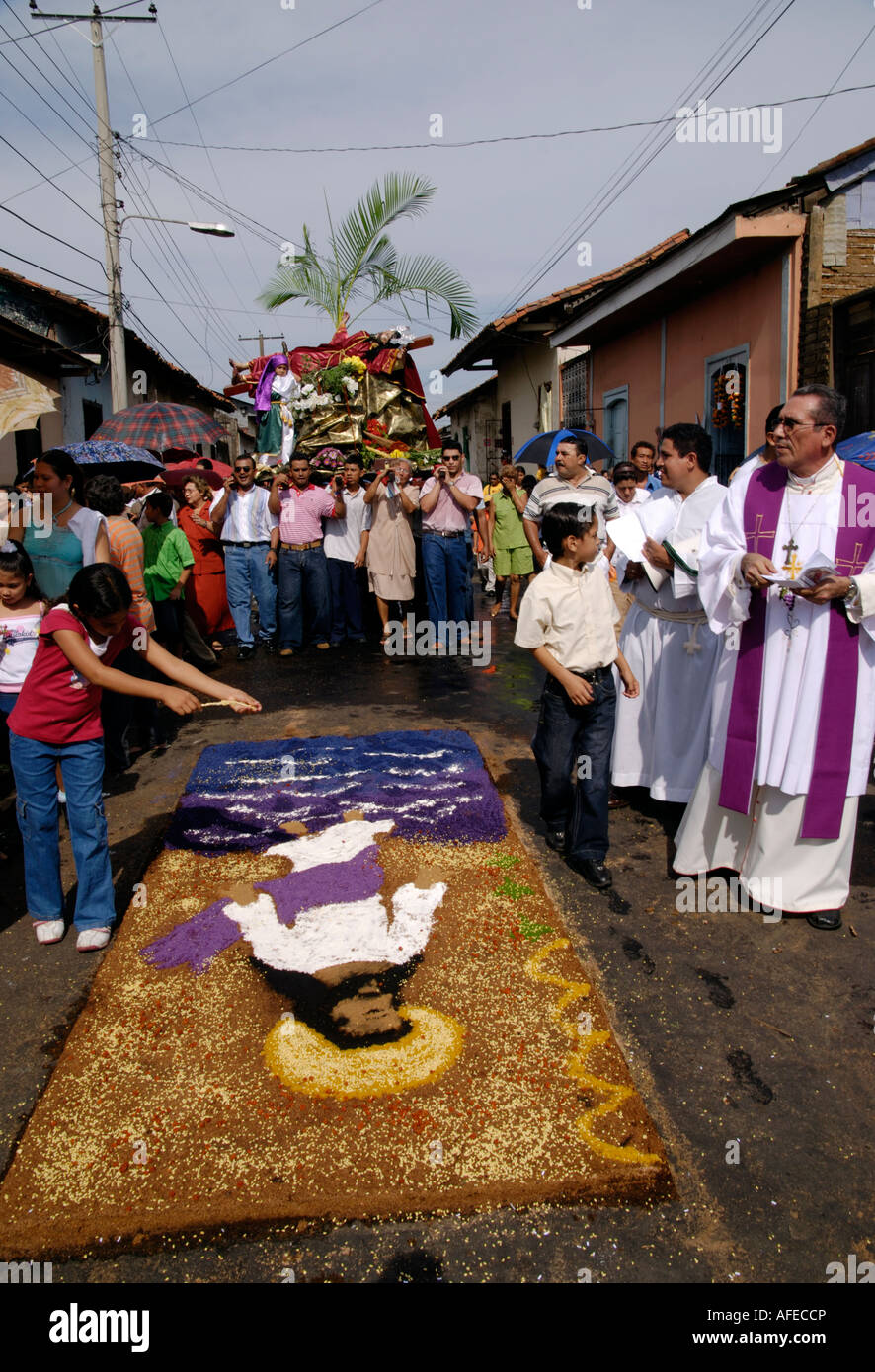 Devotees carry a model of the crucifiction over a sawdust carpet during a Semana Santa procession, Leon, Nicaragua Stock Photo