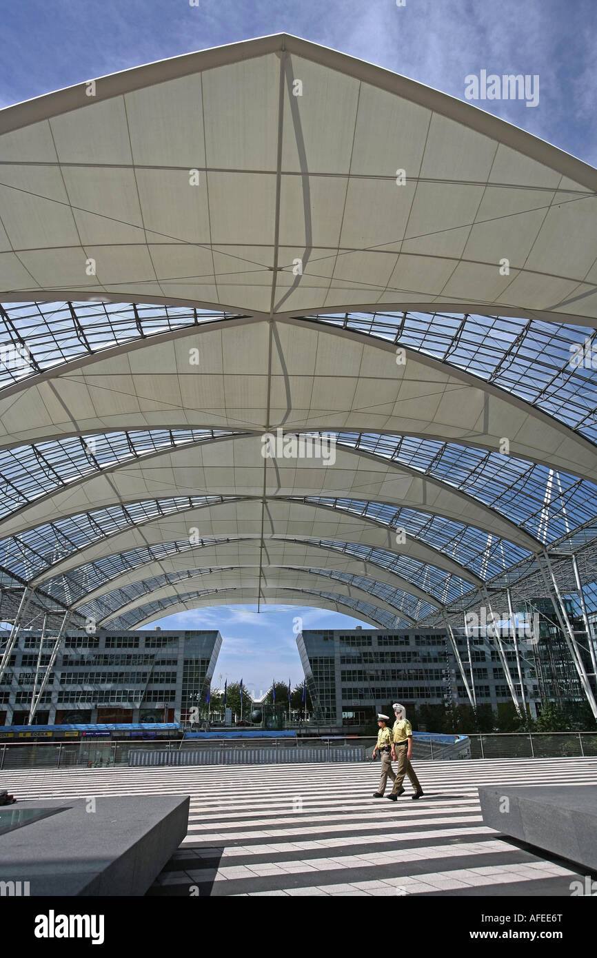Illustration Airport Police: Policemen at Munich Airport building with futuristic architecture Stock Photo