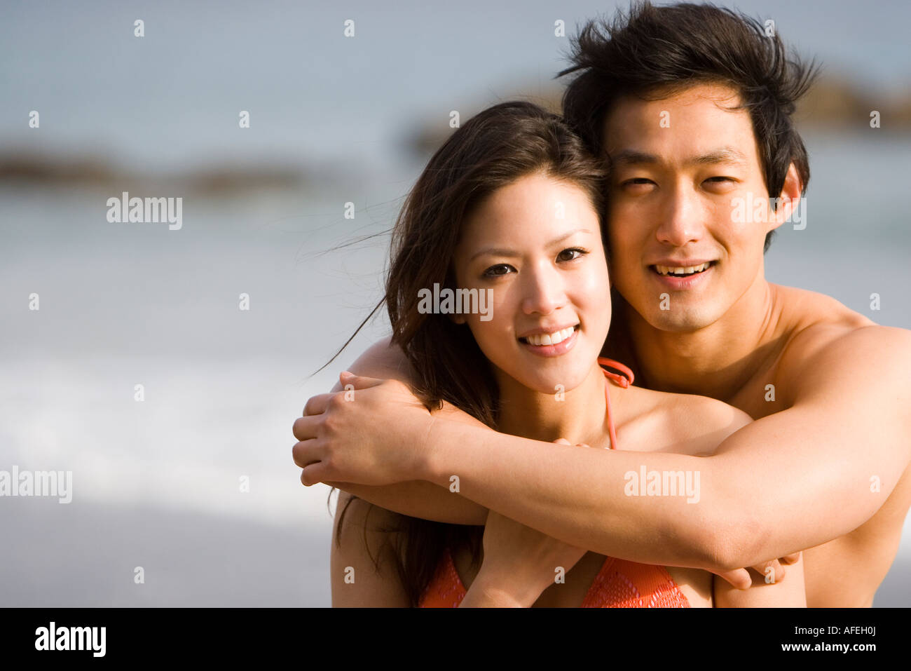 Young Asian Couple Hugging on the Beach Stock Photo - Alamy