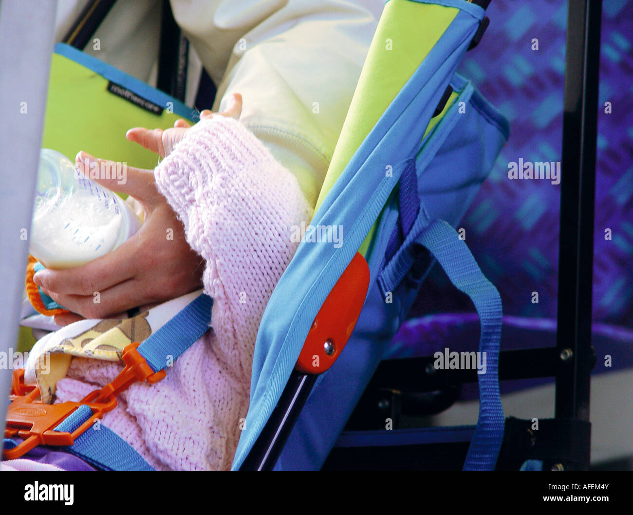 feeding baby in buggy Stock Photo Alamy