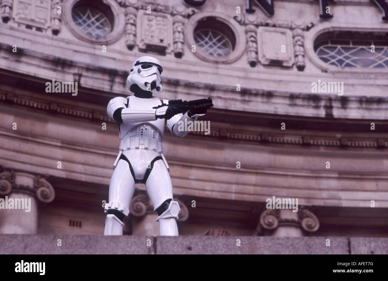 Star Wars Storm Trooper with Blaster Rifle standing guard before London County Hall, South Bank, London, England Stock Photo