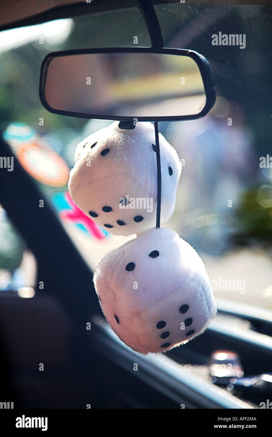 Fluffy dice hang from a Lada rear view mirror Stock Photo
