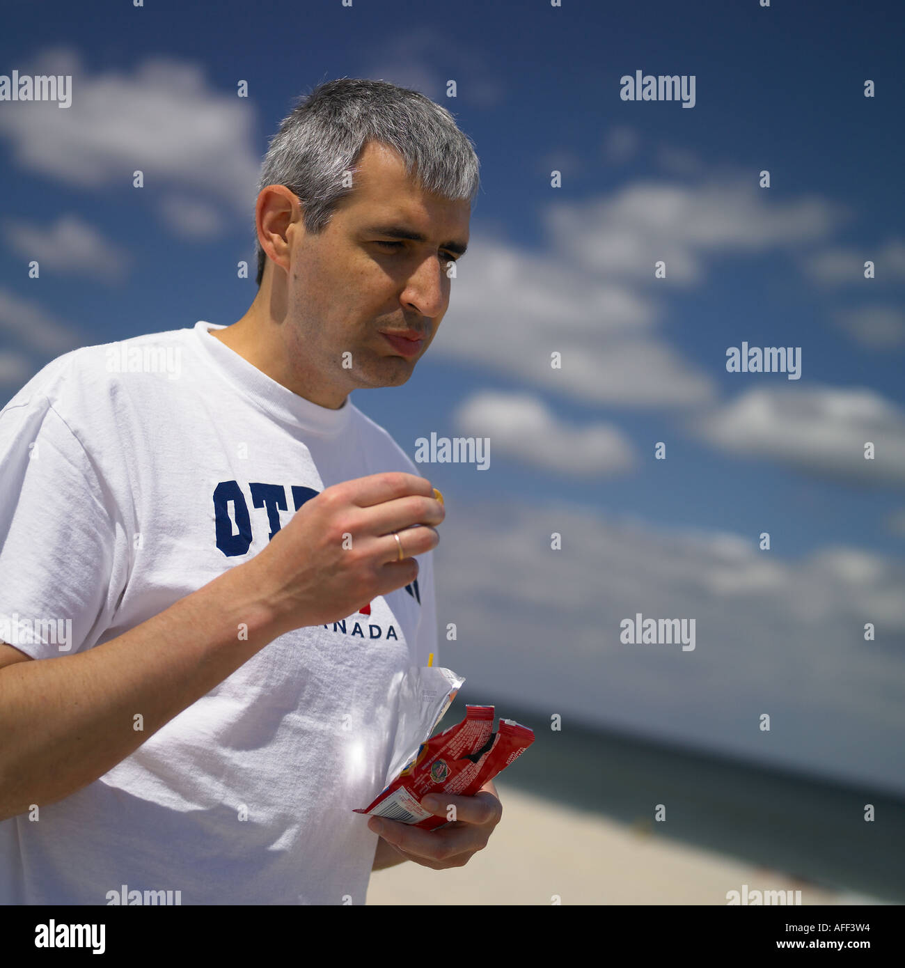man snacking at the beach Stock Photo - Alamy