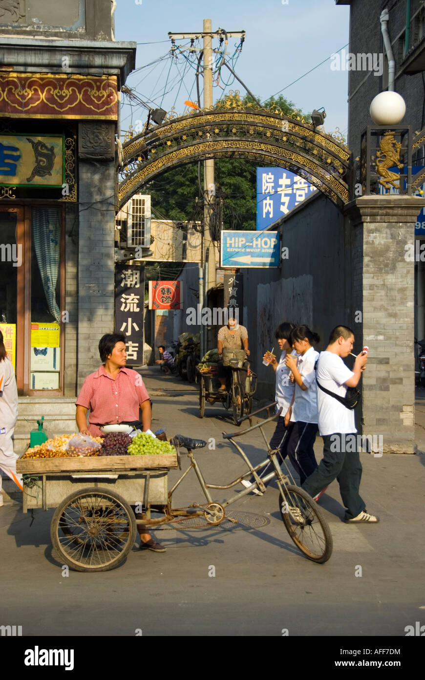 'Beijing CHINA', Old Neighborhoods 'Street Scene' Hutongs Rickshaw Fruit Saleswoman on Sidewalk in 'Juer Hutong' Houhai Area Stock Photo