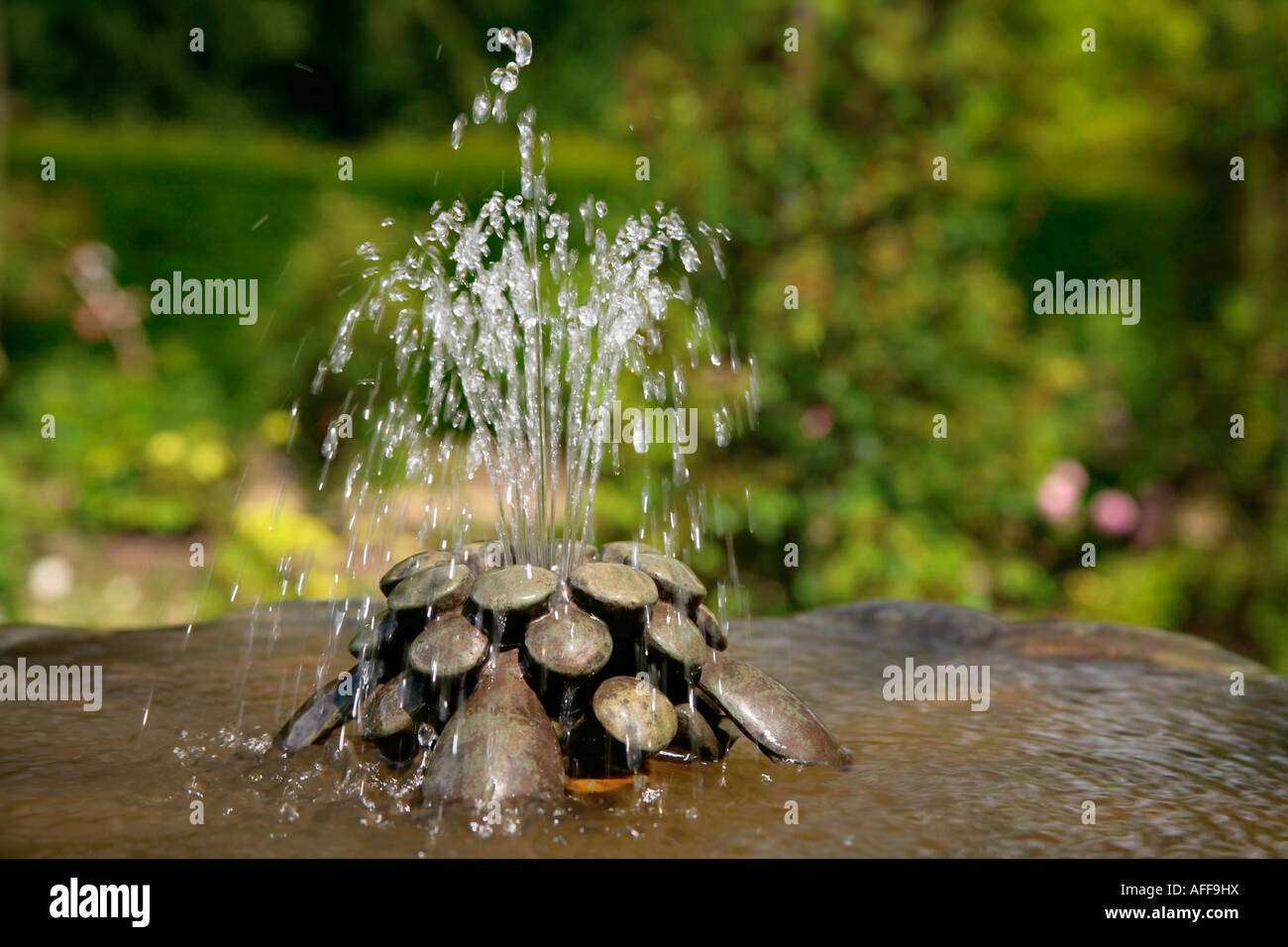 Decorative water fountain in garden Stock Photo