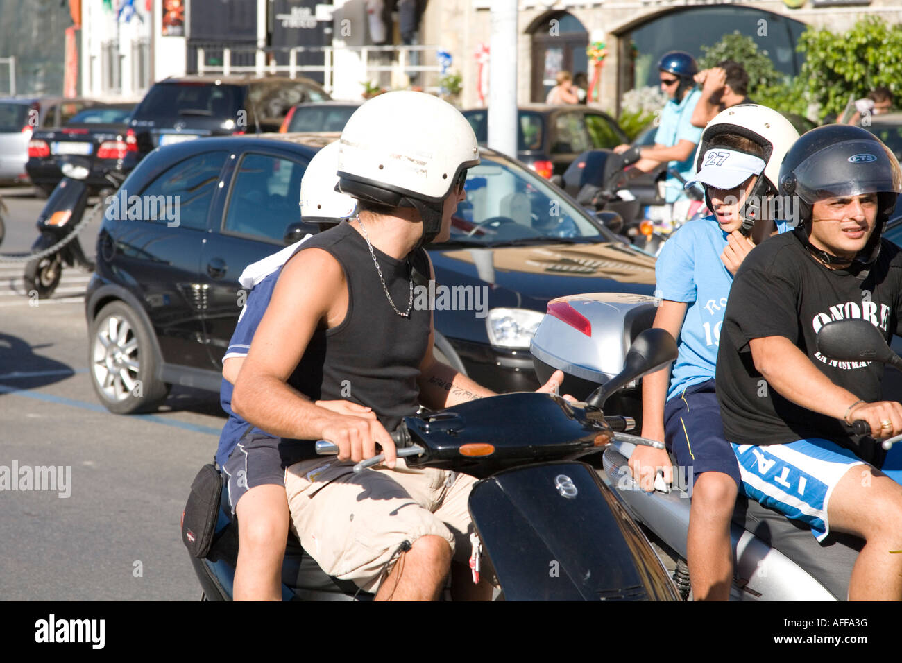 Teenagers riding mopeds in Porto Santo Stefano Monte Argentario Tuscany